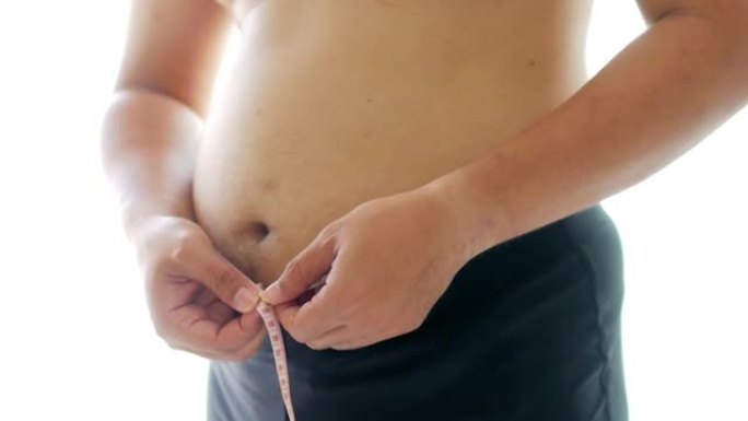 胖子用测量胶带测量腹部健康概念