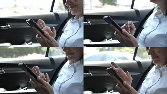在汽车中使用手机的女人的特写手