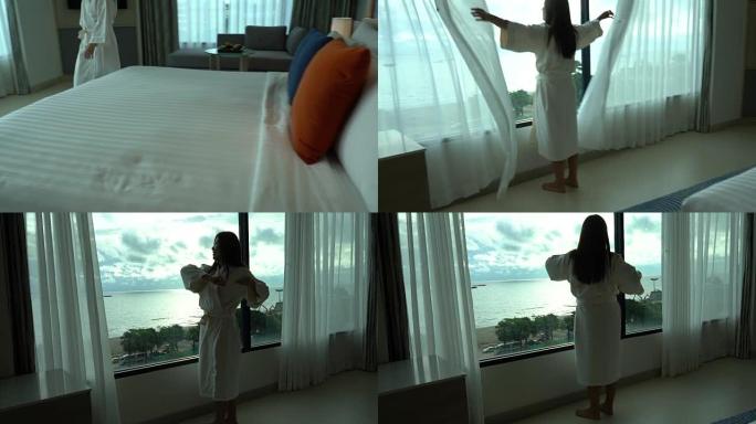 4k镜头亚洲妇女早晨醒来，在豪华酒店卧室的床上散步和看着窗户，生活方式和休闲概念