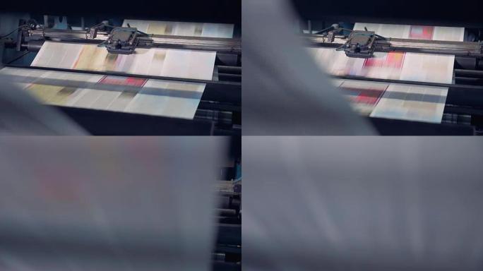 未切割的印刷纸张正在由工业设备处理，并沿其向上移动