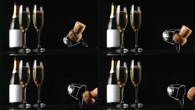 香槟软木塞落在两个玻璃杯和瓶子的前面