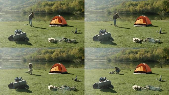 女人和她的狗在湖边玩得开心