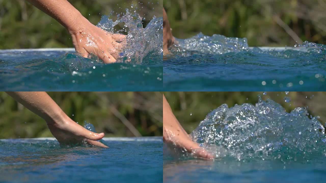 慢动作女人的手滑过水面，在游泳池里溅起水滴