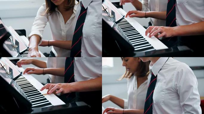女学生与老师在音乐课上弹钢琴