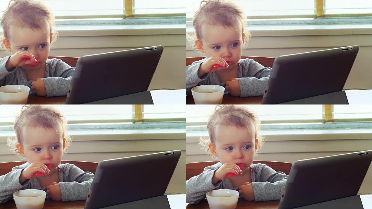 婴儿在吃早餐时使用数字平板电脑4k