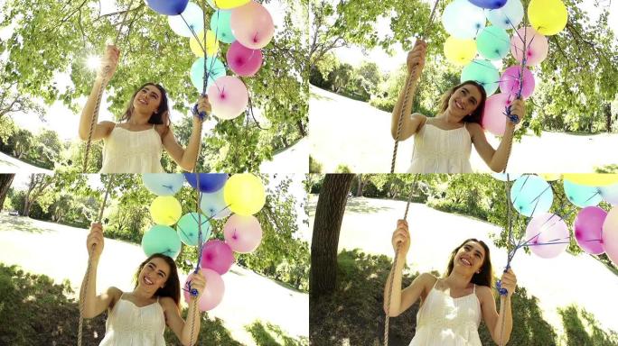年轻女子兴高采烈地挥舞着五颜六色的气球