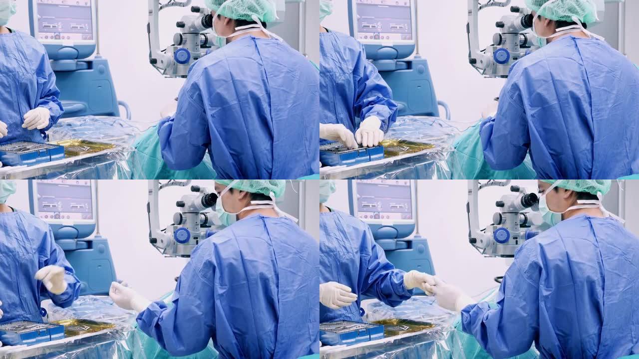 仪器护士为眼科医生外科医生添加手术工具，在手术过程中faco机器的打字监视器触摸屏眼，白内障手术，特
