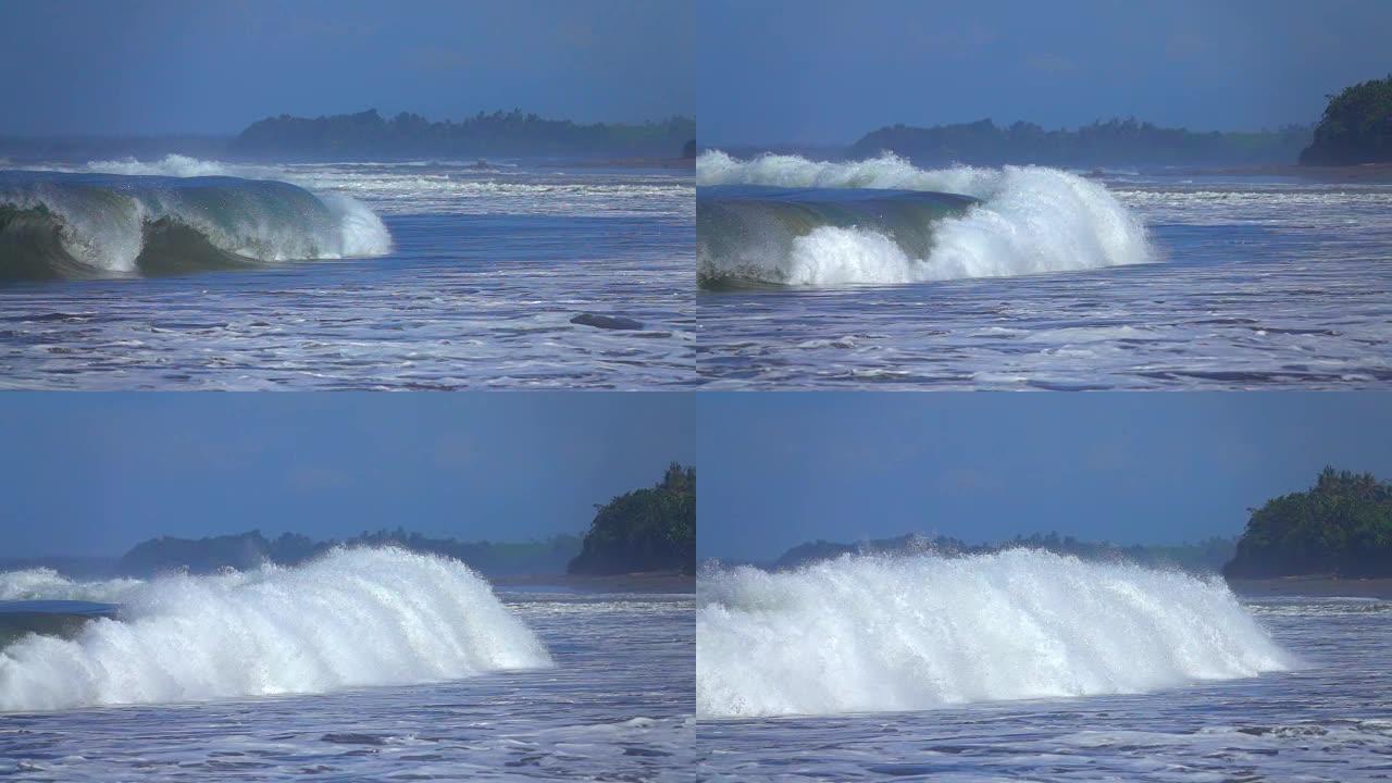 慢动作: 巨大的热带海浪在礁石上向巴厘岛海岸滚动