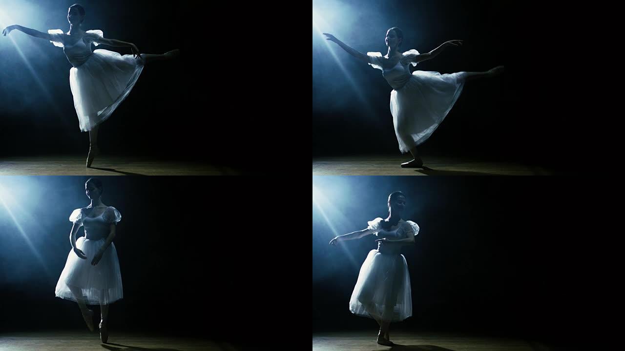 美丽的年轻芭蕾舞演员在聚光灯下优雅地跳舞，周围是黑暗。她穿着白色短裙，在灯光下闪闪发光。慢动作。