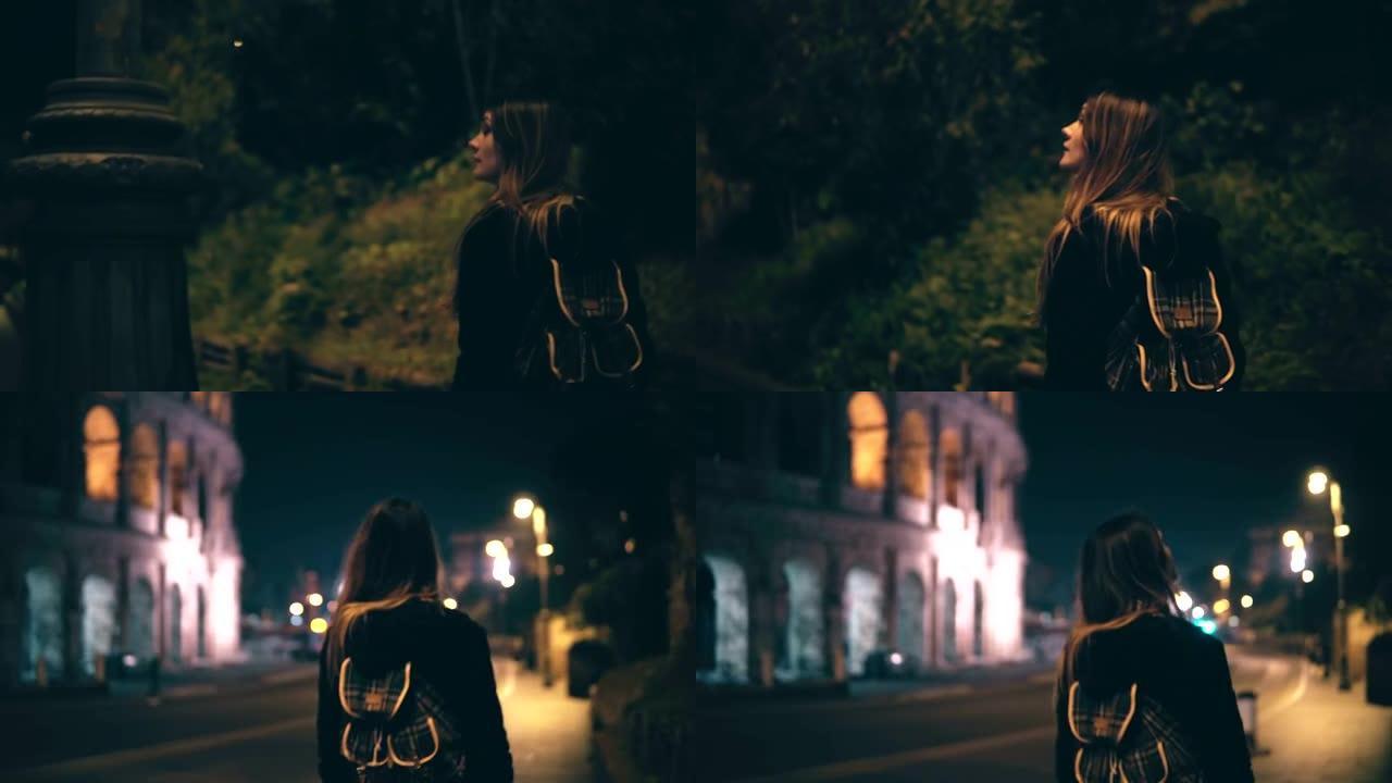 年轻迷人的女人独自在意大利罗马深夜散步。女孩穿过罗马斗兽场附近的市中心