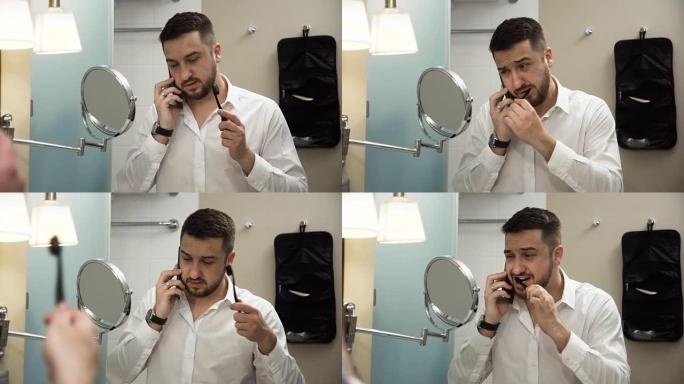 忙碌的商人在刷牙时在电话上讲话