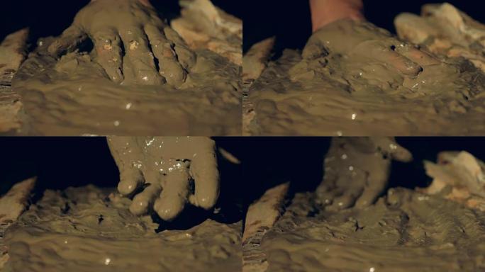 用手平整的液体粘土的特写视图。
