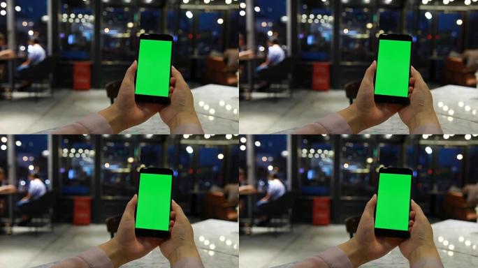 手握绿屏显示手机