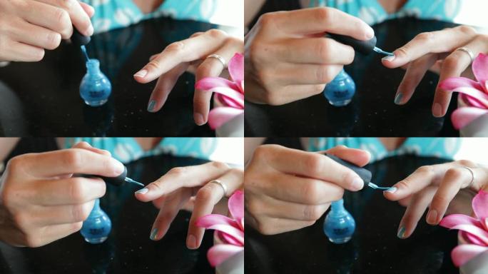 特写女性涂蓝色手指的手