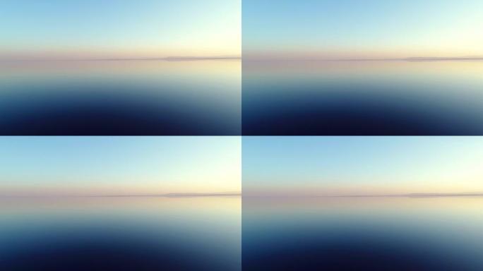 日落时湖上水反射的低空鸟瞰图