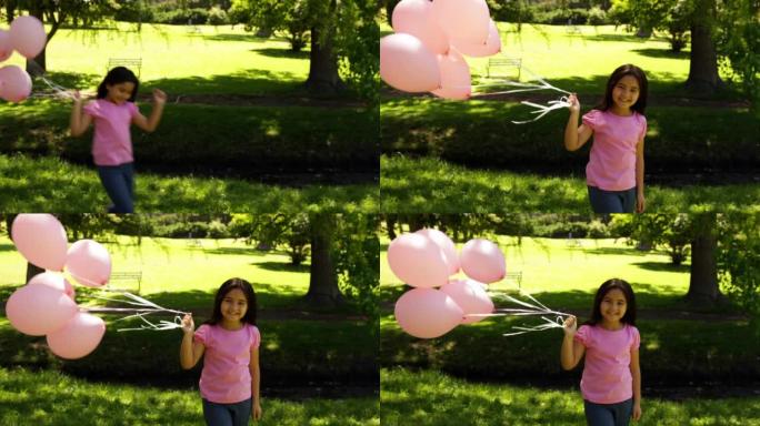 小女孩携带气球以提高对乳腺癌的认识