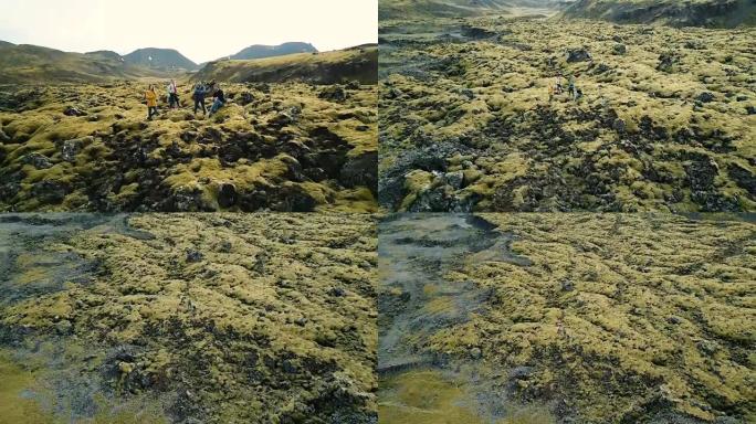 冰岛熔岩场游客的鸟瞰图。直升机远离朋友，无人机上的自拍。美丽的风景