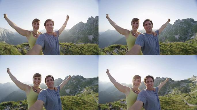肖像: 欢快的徒步旅行夫妇在高高的岩石山顶上伸出双臂