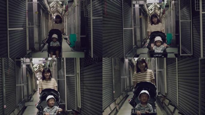 亚洲妇女推婴儿推车