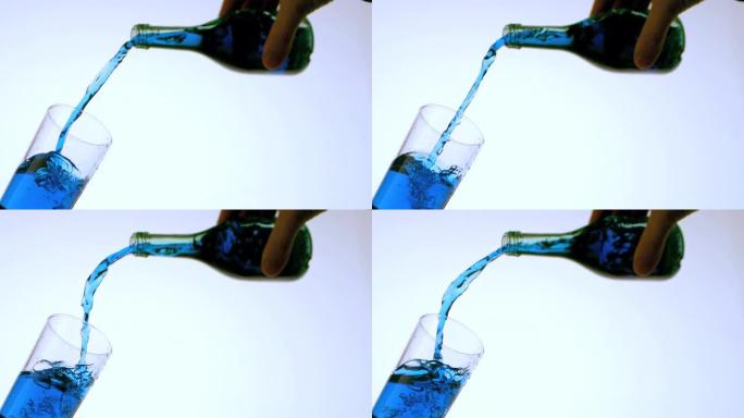 蓝色液体倒入玻璃低角度