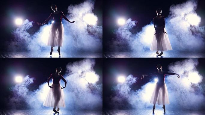 芭蕾舞演员在黑暗中做出完美的echappes。