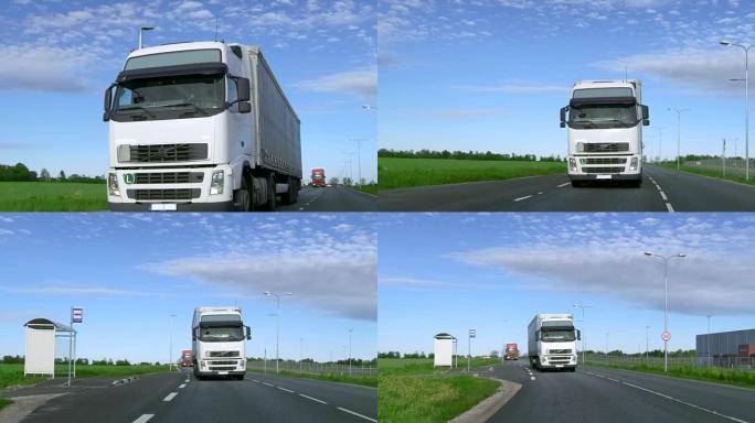 超速行驶的白色半卡车的正面视图，带有货运拖车在高速公路上行驶，背景是田野和工业仓库。