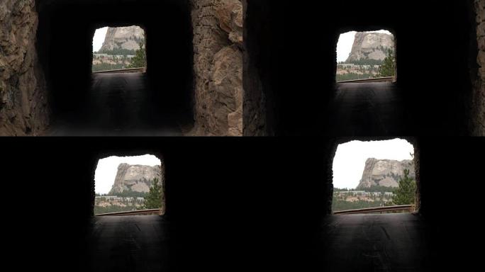 慢动作: 狭窄的岩石隧道框架的风景。拉什莫尔在远处