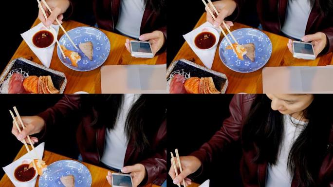 在4k餐厅使用手机时吃寿司的女人