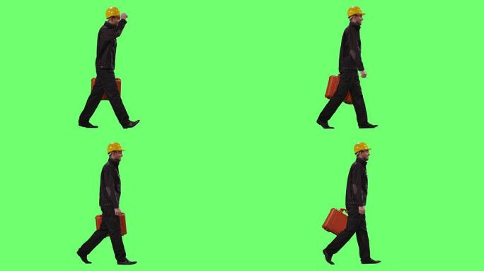 戴着安全帽的建筑工人背着装甲手提箱，正走在背景的模拟绿屏上。