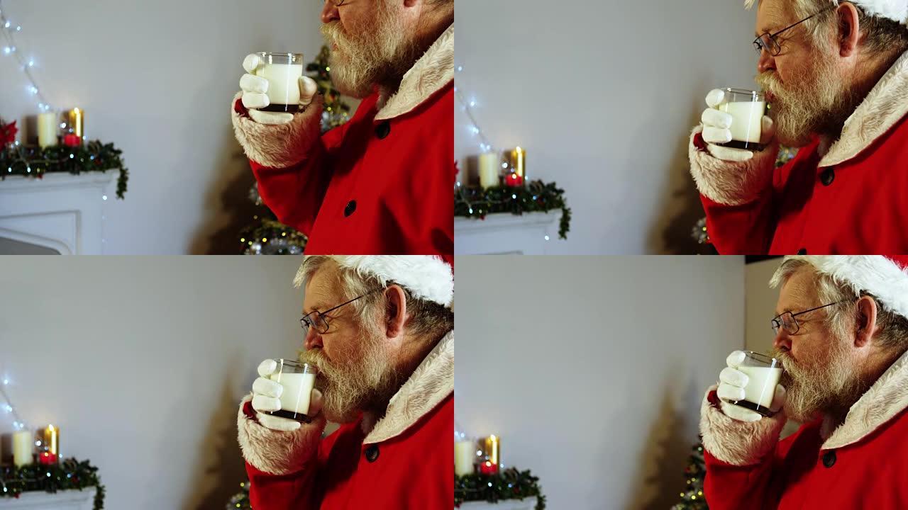 圣诞老人在椅子上放松，喝牛奶