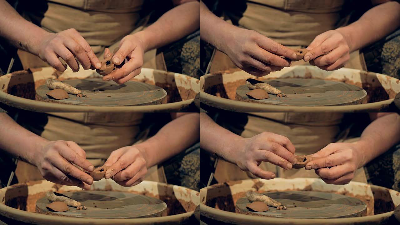 陶工手动塑造粘土勺子。