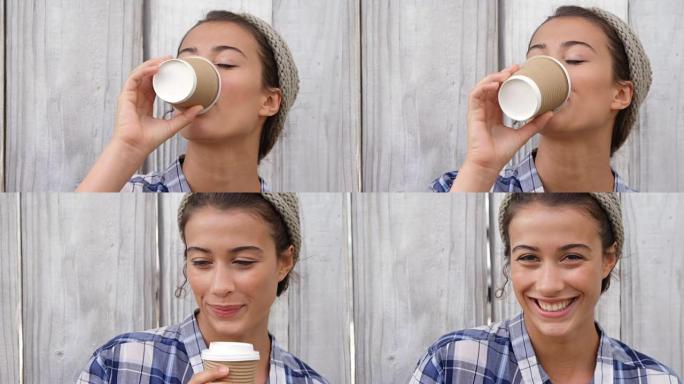 年轻女子用一次性杯子喝咖啡