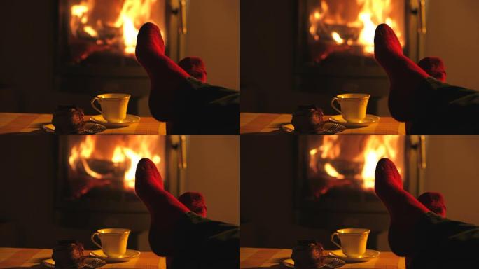 舒适的原木火使人的脚放松