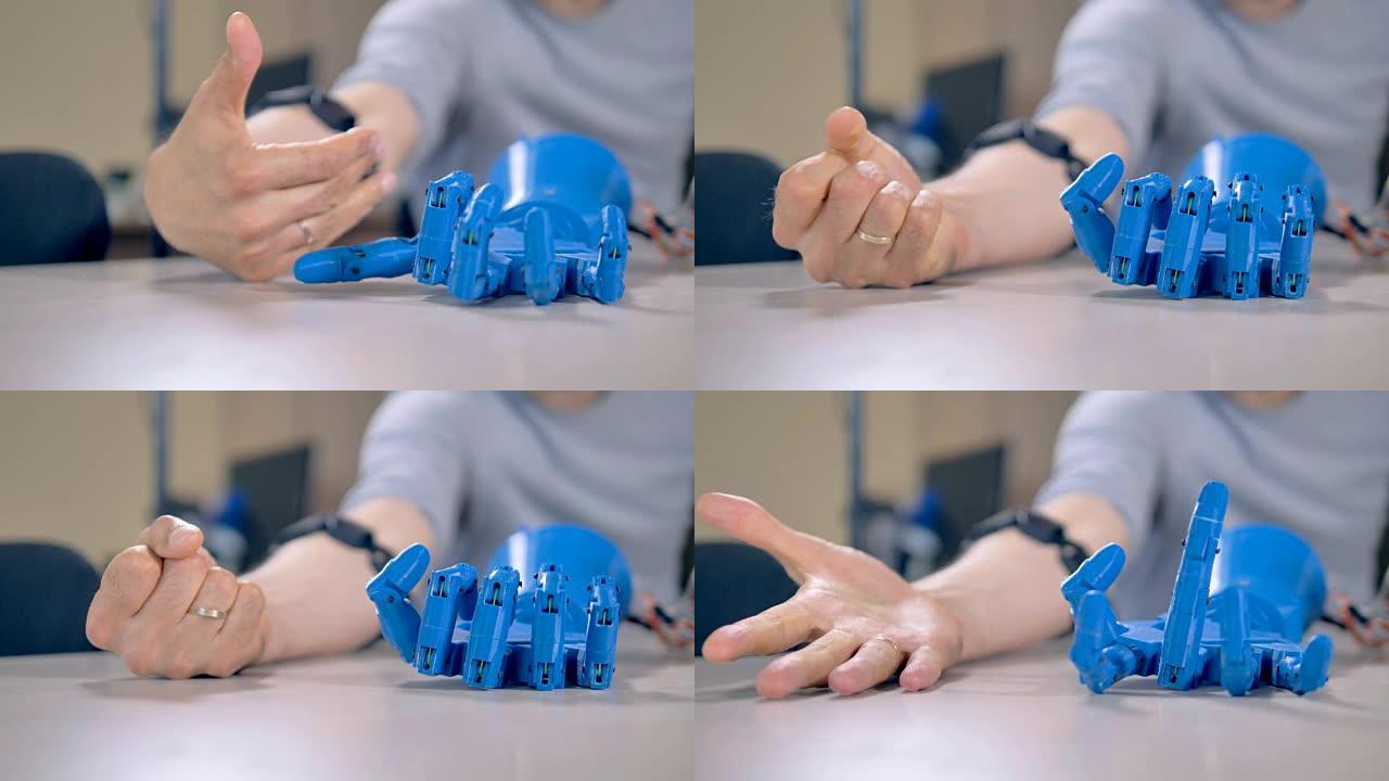 人类手臂手指为机器人做示例动作。