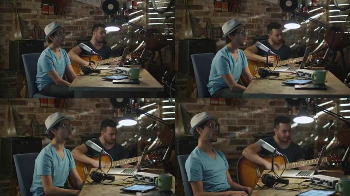 两个年轻人在车库的家庭录音室里唱歌和弹吉他。