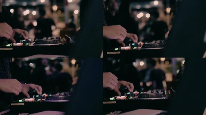 DJ hands的特写镜头在派对上的夜总会舞台上混合了曲目