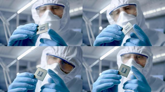在超现代电子制造工厂中，无菌工作服的设计工程师戴着手套握住微芯片并对其进行检查。