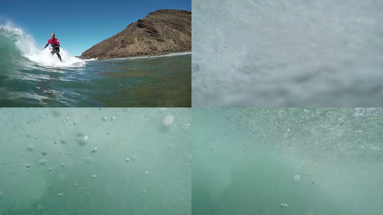 水下慢动作: 冲浪者在巨大的破浪中冲浪