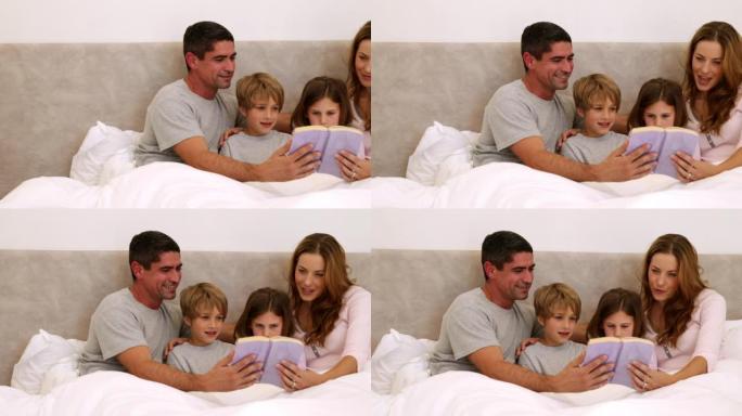 快乐的父母和孩子在床上一起阅读