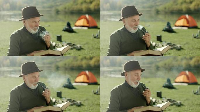 老人在湖边抽烟看书