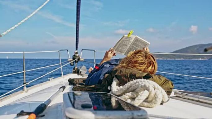 4k女人放松，在阳光帆船上看书，实时