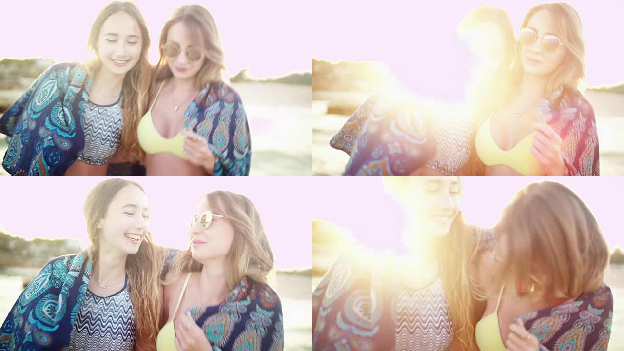 暑假的女孩在日落时在海滩散步