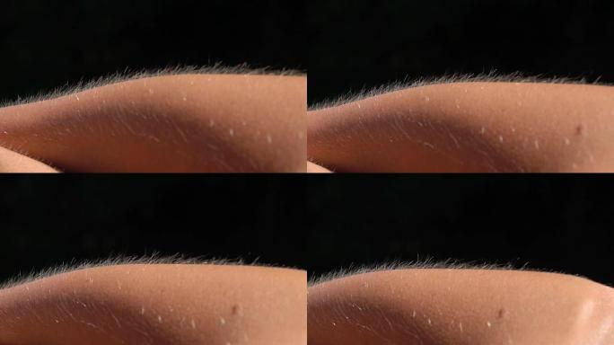 特写微距: 皮肤鸡皮疙瘩的细节，女性手臂上的头发抬起