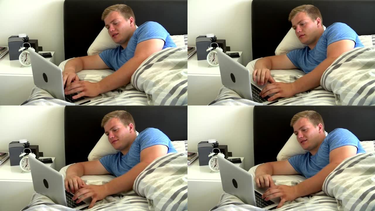 十几岁的男孩躺在床上，用笔记本电脑