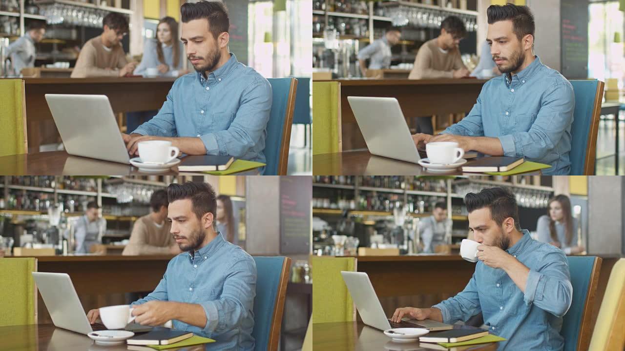 西班牙裔年轻人在舒适的咖啡店使用笔记本电脑。