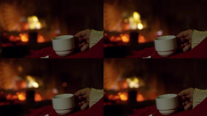4k特写女人放松，在舒适的壁炉旁喝茶，实时