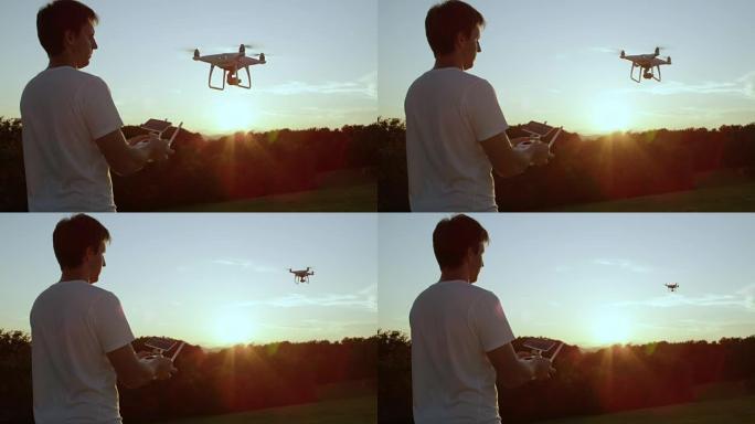 特写: 年轻的filmer男子在金色的日落时从手中发射了四轴飞行器无人机