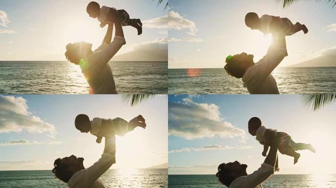 年轻的爸爸在日落时抱着婴儿