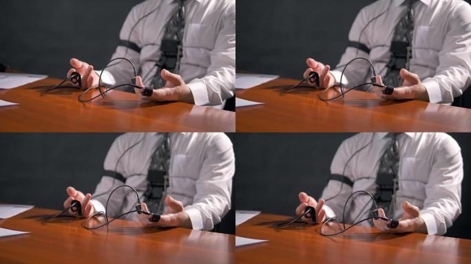 带有测谎仪传感器的男性手放在桌子上。4K 60 fps。