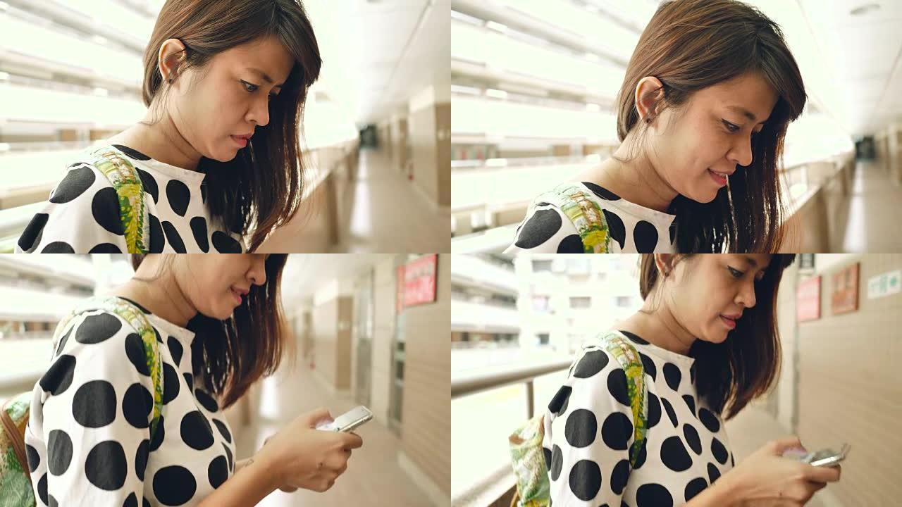 亚洲女性在公寓里使用智能手机